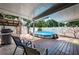 Relaxing backyard patio with chairs, grill, and an inviting above-ground pool at 11831 104Th Ln, Largo, FL 33773