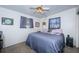 Bedroom with purple bedding and curtains, a ceiling fan and neutral walls at 11831 104Th Ln, Largo, FL 33773