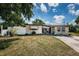 Charming single-story home with stone accents, awnings, and a well-maintained front yard at 11831 104Th Ln, Largo, FL 33773