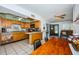 Eat-in kitchen with wood cabinetry, stainless steel appliances, and casual dining space at 11831 104Th Ln, Largo, FL 33773