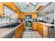 Functional kitchen with stainless steel appliances, wood cabinetry and tile floors at 11831 104Th Ln, Largo, FL 33773