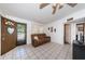 Living area featuring an exterior door, tile floors, and comfortable seating at 11831 104Th Ln, Largo, FL 33773