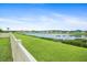 Spacious backyard showcasing well-maintained lawn and tranquil lake views, perfect for relaxation and recreation at 11911 Greenchop Pl, Riverview, FL 33579