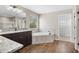 Bathroom with granite countertops, tub, wood floors and a walk-in closet at 11911 Greenchop Pl, Riverview, FL 33579