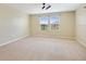 Spacious bedroom with neutral walls, carpeted floor, recessed lighting, and bright windows at 11911 Greenchop Pl, Riverview, FL 33579
