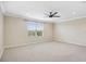 Spacious bedroom features a ceiling fan, neutral paint, plush carpeting and plenty of natural light at 11911 Greenchop Pl, Riverview, FL 33579
