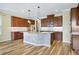 Beautiful kitchen featuring an island with barstool seating, stainless steel appliances, and wood cabinets at 11911 Greenchop Pl, Riverview, FL 33579