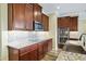 Elegant kitchen features custom wood cabinets, stainless steel appliances, and granite countertops at 11911 Greenchop Pl, Riverview, FL 33579