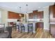 Well-equipped kitchen features an island with barstool seating, stainless steel appliances, and wood cabinets at 11911 Greenchop Pl, Riverview, FL 33579
