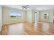 Bright living room with wood floors, large windows offering neighborhood views at 11911 Greenchop Pl, Riverview, FL 33579