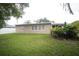 Lush backyard featuring a well-kept lawn, privacy fence, and tropical plants at 11928 Mandarin Ct, Seminole, FL 33772