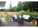 Landscaped backyard featuring outdoor seating, lush greenery, and a privacy fence at 11928 Mandarin Ct, Seminole, FL 33772