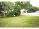 Lush backyard featuring a well-maintained lawn and a sturdy privacy fence, providing an outdoor retreat at 11928 Mandarin Ct, Seminole, FL 33772