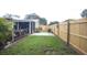 Large fenced backyard featuring a patio, green grass, and room for outdoor activities at 11928 Mandarin Ct, Seminole, FL 33772