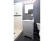 Updated bathroom with a stylish vanity, mirror, and tiled shower at 11928 Mandarin Ct, Seminole, FL 33772