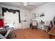 Bedroom with ceiling fan, wood floor, work desk and vanity mirror at 11928 Mandarin Ct, Seminole, FL 33772