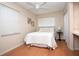 Cozy bedroom featuring neutral colors, a ceiling fan, and bright natural light at 11928 Mandarin Ct, Seminole, FL 33772