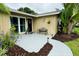 Bright entryway featuring a glass front door, side window, bench, and fresh paint at 11928 Mandarin Ct, Seminole, FL 33772