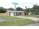 Well-kept single Gathering home featuring a manicured lawn, attached garage, and mature tropical landscaping at 11928 Mandarin Ct, Seminole, FL 33772