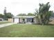Inviting single Gathering home featuring well-manicured lawn and mature trees with a light color scheme at 11928 Mandarin Ct, Seminole, FL 33772