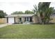 Inviting single Gathering home featuring well-manicured lawn and mature trees with a light color scheme at 11928 Mandarin Ct, Seminole, FL 33772