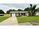 Charming single Gathering home with lush landscaping and attached garage and long driveway at 11928 Mandarin Ct, Seminole, FL 33772