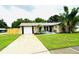 Charming single Gathering home with lush landscaping and attached garage and long driveway at 11928 Mandarin Ct, Seminole, FL 33772