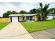 Charming single Gathering home with lush landscaping and attached garage and long driveway at 11928 Mandarin Ct, Seminole, FL 33772