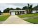 Charming single Gathering home with lush landscaping and attached garage and long driveway at 11928 Mandarin Ct, Seminole, FL 33772
