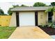 Home featuring a two-car garage, a well-maintained driveway, and an inviting exterior at 11928 Mandarin Ct, Seminole, FL 33772