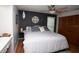 Comfortable primary bedroom featuring a queen bed, stylish accent wall, and ensuite bathroom at 11928 Mandarin Ct, Seminole, FL 33772