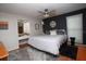 Beautiful primary bedroom featuring a queen bed, stylish accent wall, and vanity area at 11928 Mandarin Ct, Seminole, FL 33772