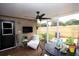 A screened-in patio with a ceiling fan, comfortable lounge chair, and outdoor decor at 11928 Mandarin Ct, Seminole, FL 33772