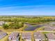 Aerial view of the neighborhood showcasing lush greenery, lake, and surrounding houses at 12107 Nouveau Ave, Spring Hill, FL 34610