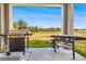 Covered back porch with a gas grill and griddle for outdoor cooking at 12107 Nouveau Ave, Spring Hill, FL 34610