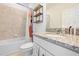 Bright bathroom featuring a granite countertop, white cabinets, tub, and toilet at 12107 Nouveau Ave, Spring Hill, FL 34610