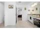 Bright bathroom features double sinks with granite counters and a doorway to the Primary bedroom at 12107 Nouveau Ave, Spring Hill, FL 34610
