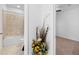 A tiled bathroom features a tub and shower combo adjacent to a neutral-toned bedroom at 12107 Nouveau Ave, Spring Hill, FL 34610