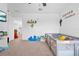Bright bedroom featuring personalized wall decorations and a variety of toys and a playard at 12107 Nouveau Ave, Spring Hill, FL 34610