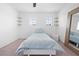 Cozy bedroom features a comfortable bed, fan, and plenty of natural light at 12107 Nouveau Ave, Spring Hill, FL 34610