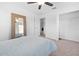 Bedroom with plush carpeting, a ceiling fan, a mirror and ample closet space at 12107 Nouveau Ave, Spring Hill, FL 34610