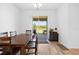 Dining room with wood table and chairs next to sliding glass doors at 12107 Nouveau Ave, Spring Hill, FL 34610