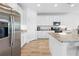 Kitchen featuring stainless steel refrigerator, white cabinets, and granite countertops at 12107 Nouveau Ave, Spring Hill, FL 34610