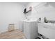 Convenient laundry room with washer, dryer, utility sink, and storage shelf at 12107 Nouveau Ave, Spring Hill, FL 34610