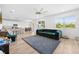 Open floor plan connecting the living room to the kitchen and dining, featuring a stylish, green sofa at 12107 Nouveau Ave, Spring Hill, FL 34610