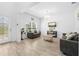 Charming living room boasting stylish decor, wood-look ceramic tile, and lots of natural light at 12107 Nouveau Ave, Spring Hill, FL 34610