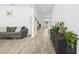 Open concept living room area featuring decorative plants and wood-look ceramic tile at 12107 Nouveau Ave, Spring Hill, FL 34610