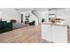 Bright, open-plan living space connected to kitchen featuring wood-look tile floors at 12107 Nouveau Ave, Spring Hill, FL 34610