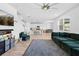 Open-concept living room showcases the kitchen and dining area, along with a comfortable, stylish, green sofa at 12107 Nouveau Ave, Spring Hill, FL 34610