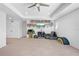Spacious loft featuring neutral carpet, television, shelving, and unique decorations at 12107 Nouveau Ave, Spring Hill, FL 34610